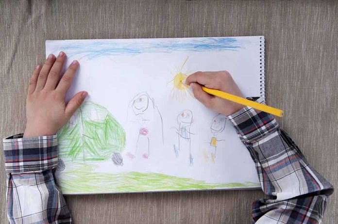 shutterstock_136666409.jpg Child drawing a colorful outdoor scene with figures and a sun