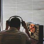 Disturbing Tape Too Traumatic For Human Ears Person listening to a vintage tape recorder with headphones