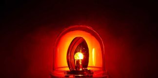 Red emergency light illuminated against a dark background