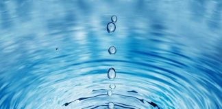 Water droplets creating ripples on a surface.