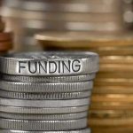 Stack of coins labeled funding with other coins stacks