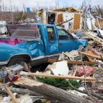 Applebee’s Manager SAVES 50 Lives A blue truck surrounded by debris and destruction from a natural disaster