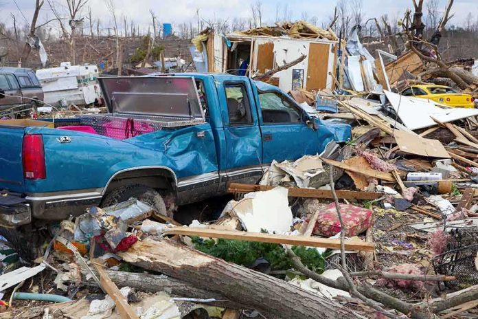shutterstock_124544536.jpg A blue truck surrounded by debris and destruction from a natural disaster