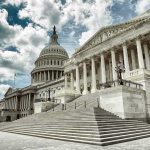 The U.S. Capitol building with a cloudy sky backdrop