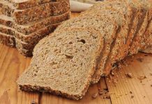 Slices of whole grain bread arranged on a wooden table