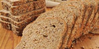 Slices of whole grain bread arranged on a wooden table