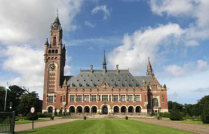 A historic building with a tall clock tower and ornate architecture set against a cloudy sky