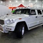 A large white luxury SUV displayed at an auto show