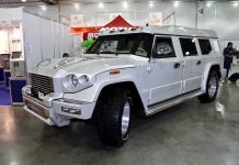 A large white luxury SUV displayed at an auto show