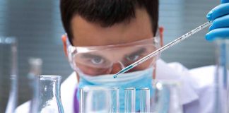 Federal Money FLOODS Trade Schools—Diplomas Not Needed! Scientist pipetting blue liquid into test tubes.