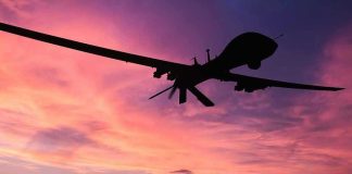 Drone Panic Exposes Security Fears Silhouette of a drone against a colorful sunset.