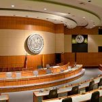 Supreme Ruling Ignites Southern Gerrymander Frenzy Interior view of a government chamber with wooden paneling and seating