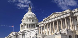 EXPULSION SHOCK: Omar Targeted in Wild Fraud Claims The U.S. Capitol building with its dome and columns under a blue sky