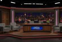 Late night talk show set with city backdrop