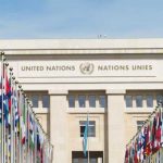 United Nations building with rows of world flags