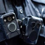 Close-up of a police officer's body camera and communication device