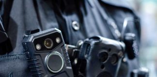 Close-up of a police officer's body camera and communication device