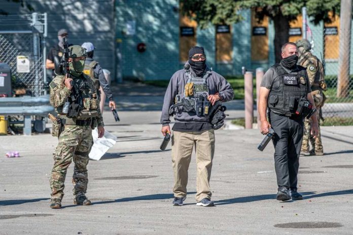shutterstock_2683835855 Law enforcement officers in tactical gear during an operation