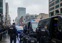 Police officers conducting an operation in an urban area with a crowd present