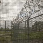 Crocodile Moats? Country Pushes Wild Prison Plan Barbed wire on chain-link fence at a prison yard