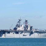 Aircraft carrier sailing on calm blue water
