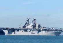 Aircraft carrier sailing on calm blue water