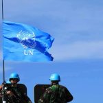 Trump’s Risky Mideast Bet Hooks US UN flag above peacekeepers in blue helmets