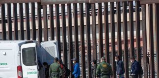 Salt Or Meth? HOUSTON Shootout Twist Border agents escort a group near a tall fence and a patrol van