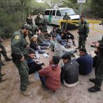 Conflict Warning: ICE Investigates ICE? Border agents surround a seated group near a van