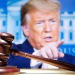 Trump’s ‘Roadkill’ Joke Rattles D.C. judge’s gavel with a blurred person pointing in the background