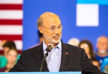 Man speaking at a podium with microphone