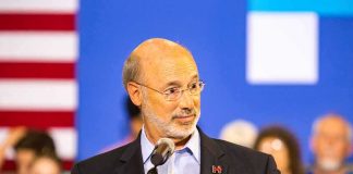 Man speaking at a podium with microphone