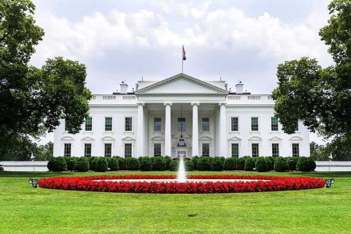 shutterstock_1016809915 The White House with fountain and red flower bed