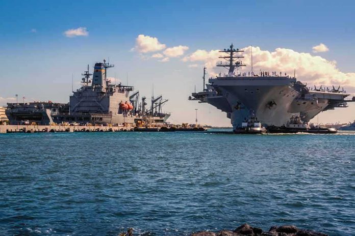 shutterstock_1074924482 Aircraft carrier and support ships docked at a naval harbor