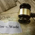 Judge's gavel on U.S. Constitution with Roe v. Wade note