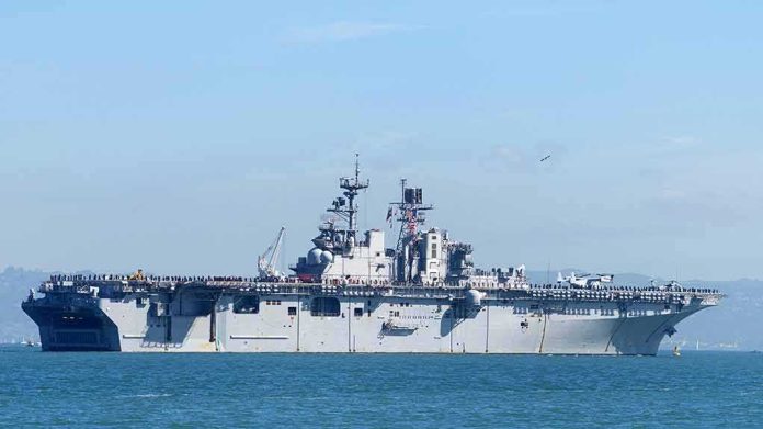 shutterstock_1196717440 Aircraft carrier sailing on calm blue water
