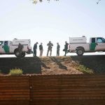 Northern Border Becomes a ‘Major Problem’ Says Border Patrol Border patrol agents stand between two trucks on a ridge