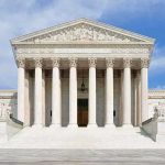 Roberts Greenlights $400M Ballroom Front view of the Supreme Court building with large columns and steps under a blue sky