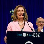 Pelosi Claims She Didn’t Know About Biden’s Decline and Gushes Over Newsom woman in pink blazer speaking at a podium