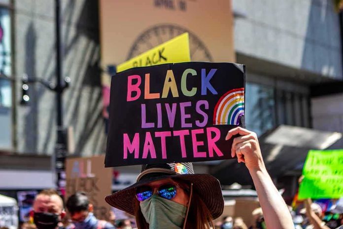 protester holds colorful sign at a city street demonstration