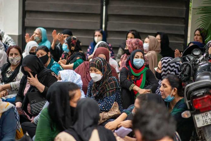 Group of women wearing face masks seated outdoors