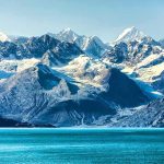 Himalayan Ice Bomb Levels Border Towns Snow-capped mountains with glaciers above a turquoise lake