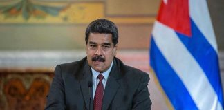 Nicolás Maduro speaking at a podium with a microphone