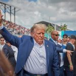 Trump Gets Rockstar Welcome at Patriot Games Final Donald Trump waving while walking through a crowded outdoor event