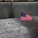 Trump Reacts to the 9/11 Name-Reading AOC and Mamdani Clip and Said THIS American flag on a rainy memorial nameplate.
