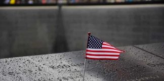 Trump Reacts to the 9/11 Name-Reading AOC and Mamdani Clip and Said THIS American flag on a rainy memorial nameplate.
