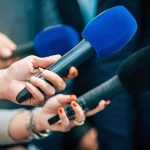 See What Radical Liberals Did to Charlie Kirk’s Statue Reporters holding colorful microphones