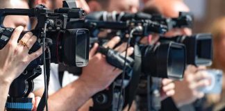 television cameras on tripods at a media event
