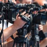 El-Sayed Refuses to Cut Ties With Streamer Who Said ‘America Deserved 9/11’ television cameras on tripods at a media event