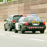 Dashcam Shows Cruiser Rear-Ended by Careless Driver Police car with flashing lights stops a minivan on highway